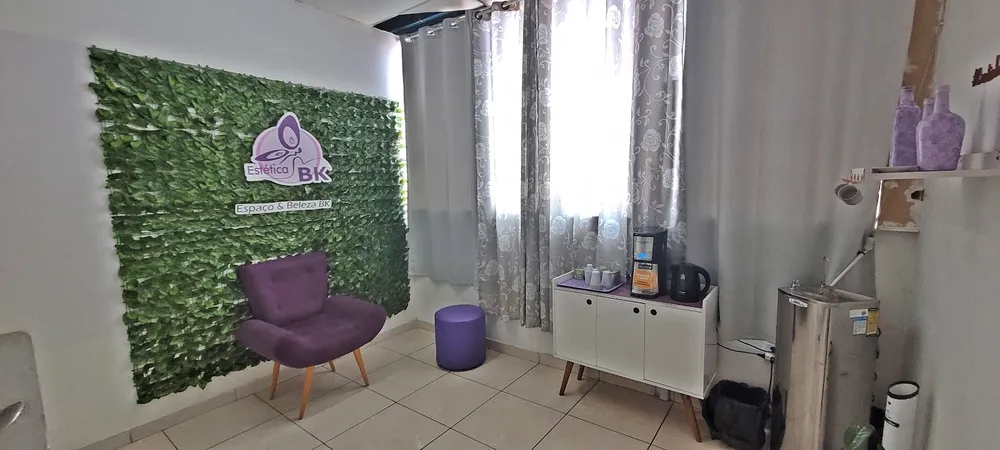Espaço acolhedor da Estética BK, com o painel verde e a poltrona